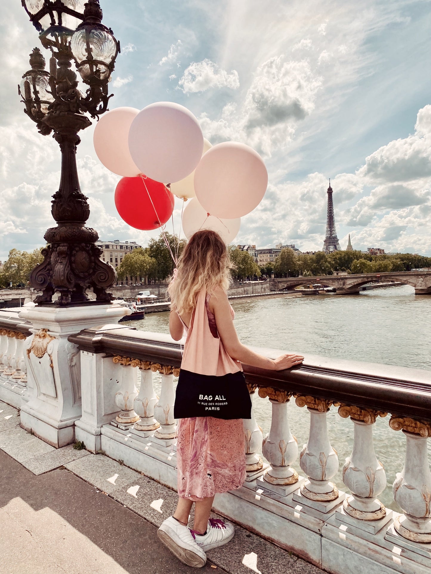 
                                      
                                        Girl in Paris holding balloons with a bag all tote bag. 
                                      
                                    