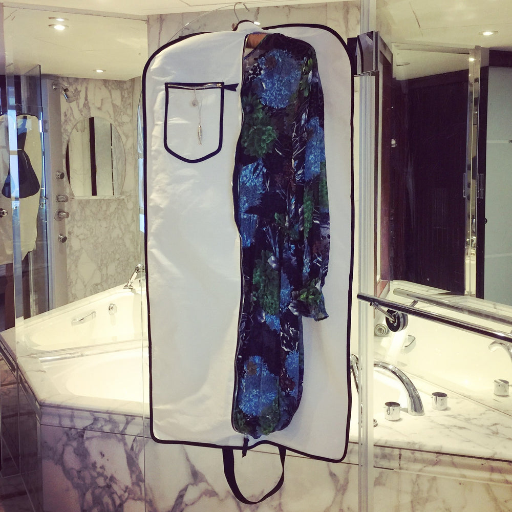 
                                      
                                        Marble bathroom with a garment dress bag hanging in the bathroom. 
                                      
                                    